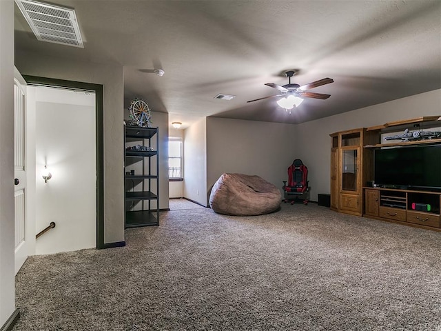 unfurnished room with visible vents, ceiling fan, and carpet floors