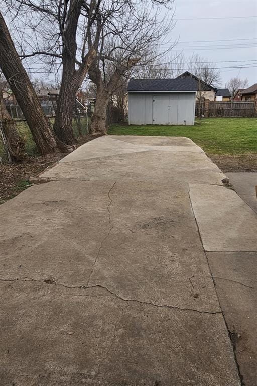 exterior space featuring an outdoor structure and fence