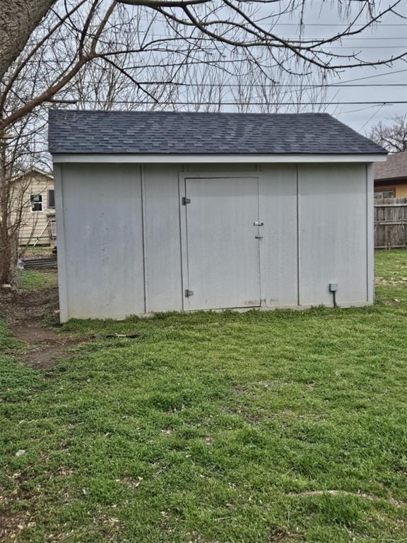 view of shed featuring fence