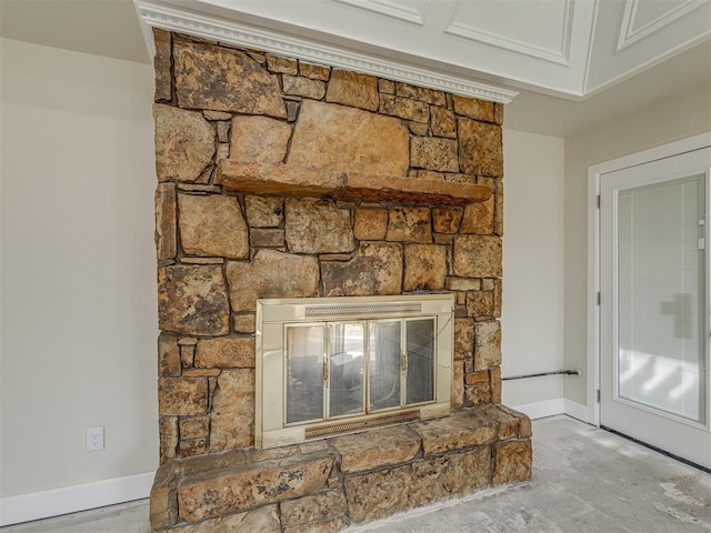 interior details with a stone fireplace and baseboards