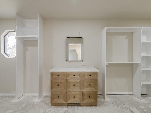 bathroom featuring concrete flooring and vanity