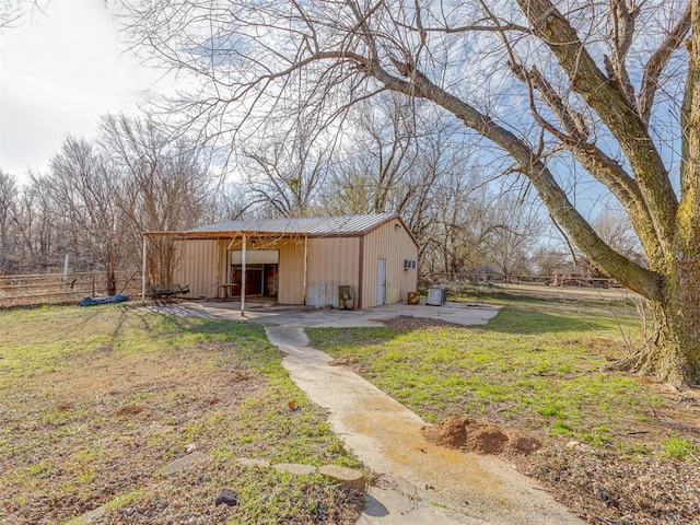 view of pole building with a yard and fence