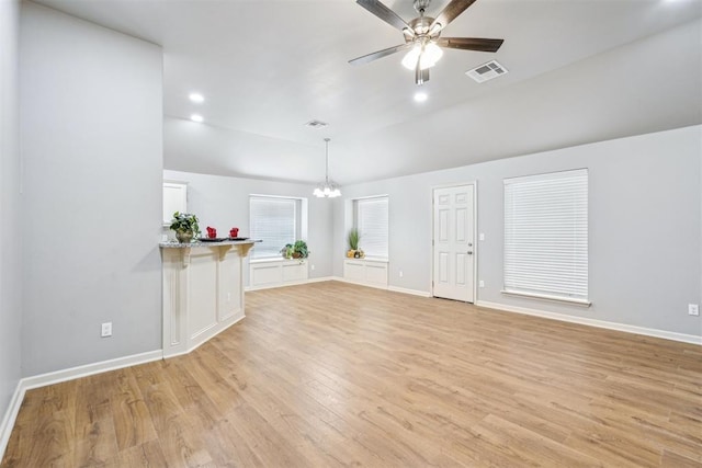 unfurnished living room featuring visible vents, ceiling fan with notable chandelier, baseboards, and light wood-style floors