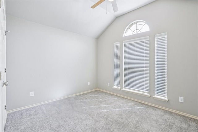 unfurnished room featuring lofted ceiling, baseboards, carpet floors, and ceiling fan