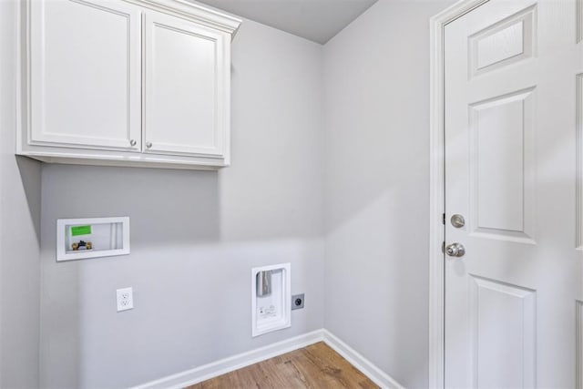 clothes washing area featuring baseboards, washer hookup, wood finished floors, cabinet space, and electric dryer hookup