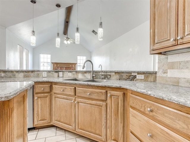 kitchen featuring light tile patterned floors, light stone countertops, visible vents, ceiling fan, and a sink