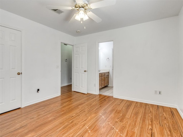 unfurnished bedroom with light wood finished floors, visible vents, and baseboards