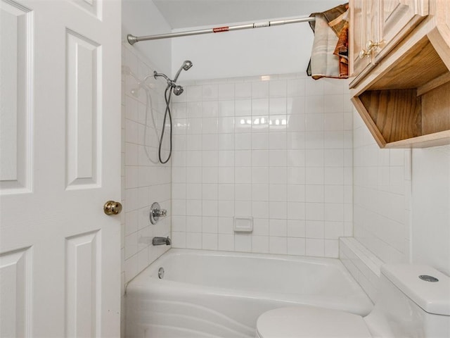 bathroom featuring tub / shower combination and toilet