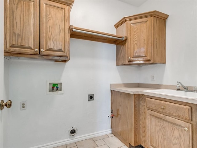 washroom with baseboards, hookup for a washing machine, cabinet space, electric dryer hookup, and a sink