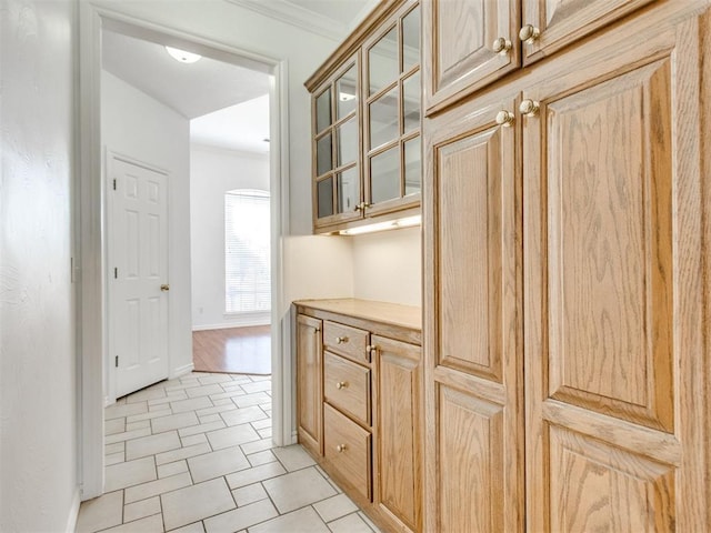 interior space with baseboards, arched walkways, and ornamental molding