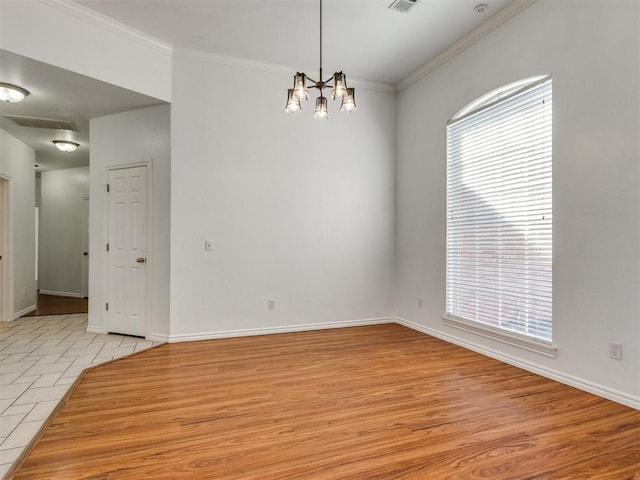 unfurnished room with visible vents, baseboards, light wood-style flooring, and crown molding