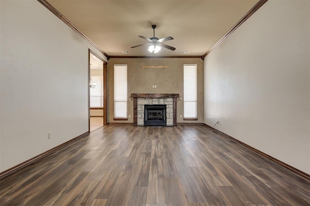 unfurnished living room featuring a fireplace, wood finished floors, crown molding, and a ceiling fan