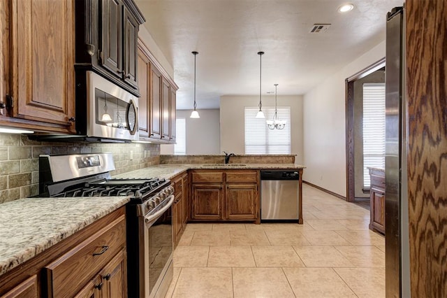 kitchen featuring tasteful backsplash, visible vents, light tile patterned floors, appliances with stainless steel finishes, and a sink