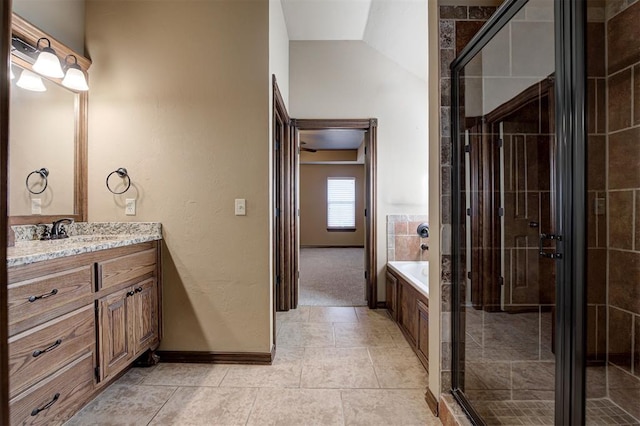 bathroom featuring vanity, a shower stall, tile patterned floors, and lofted ceiling