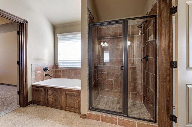 full bathroom featuring a bath, a shower stall, and tile patterned floors