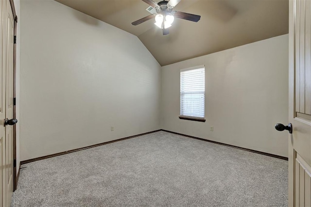 unfurnished room with carpet, lofted ceiling, a ceiling fan, and baseboards