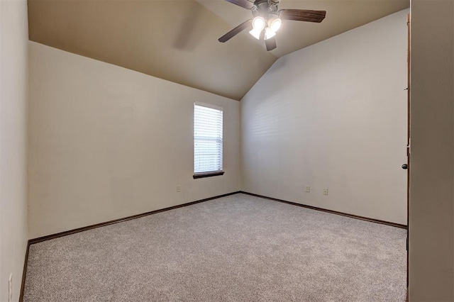 unfurnished room featuring vaulted ceiling, baseboards, carpet floors, and ceiling fan