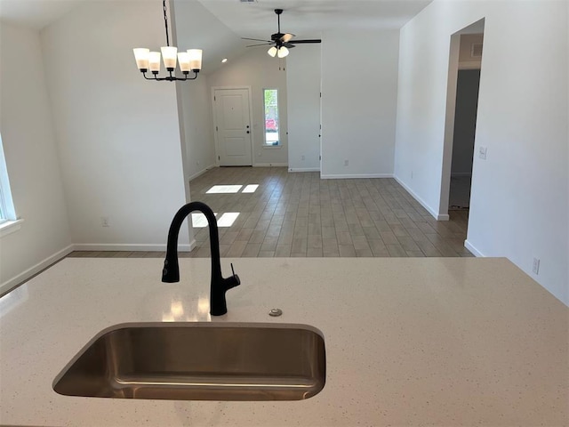2948 NW 196th Pl, Edmond, OK 73012 - kitchen featuring a sink, ceiling fan, baseboards, a chandelier, and lofted ceiling
