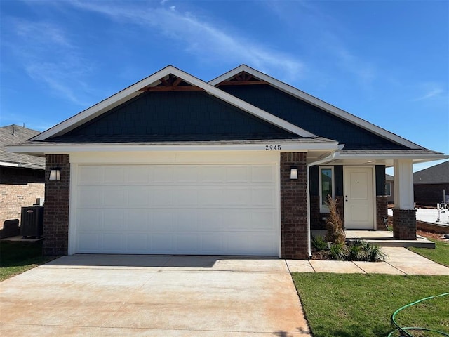 2948 NW 196th Pl, Edmond, OK 73012 - ranch-style home featuring driveway, an attached garage, central air condition unit, and brick siding