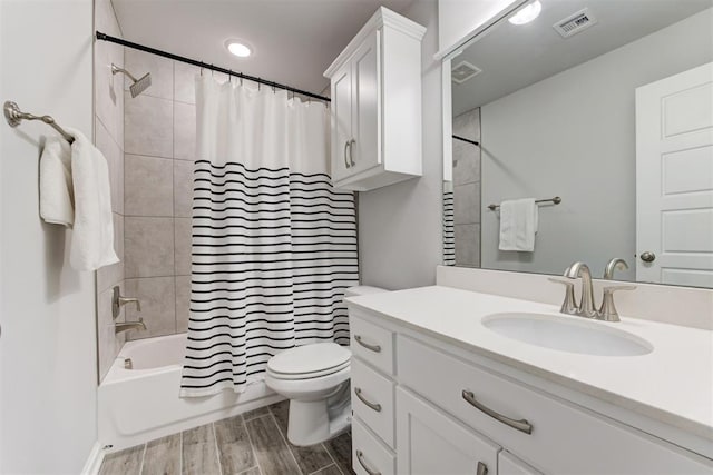 full bath featuring shower / tub combo, toilet, visible vents, and vanity