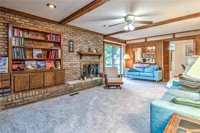 living area with beamed ceiling, visible vents, a textured ceiling, carpet, and ceiling fan