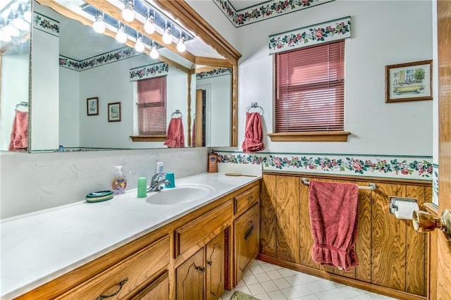 bathroom with vanity, wooden walls, and a wainscoted wall