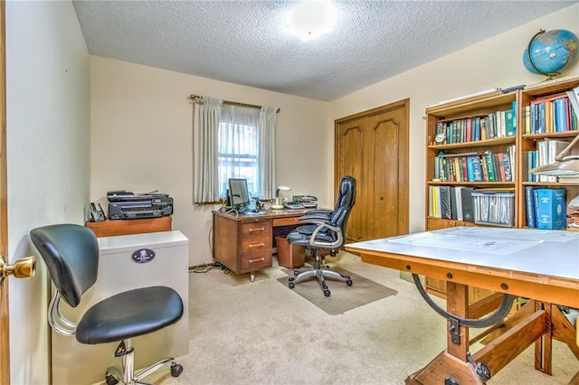 office with light colored carpet and a textured ceiling