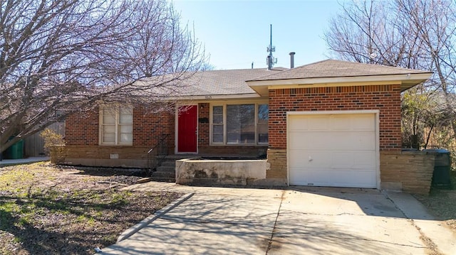 ranch-style home with concrete driveway, a garage, brick siding, and roof with shingles