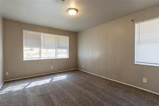 carpeted spare room with a decorative wall