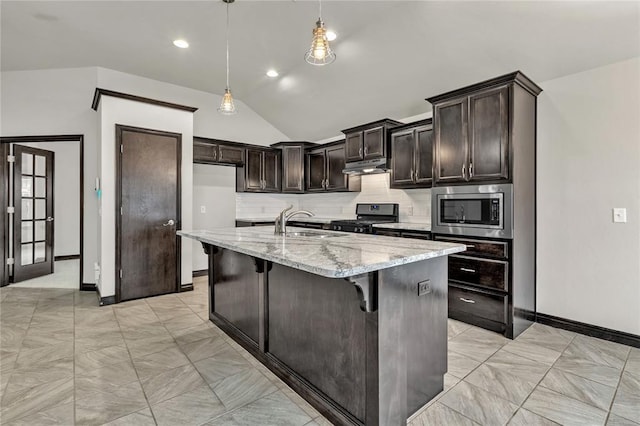 kitchen featuring under cabinet range hood, light stone counters, stainless steel appliances, decorative backsplash, and lofted ceiling