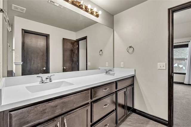 bathroom with a sink, visible vents, and double vanity