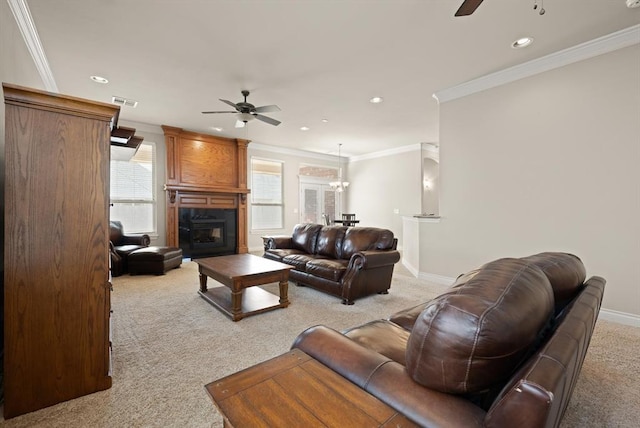 living room featuring ornamental molding, baseboards, a ceiling fan, and carpet floors