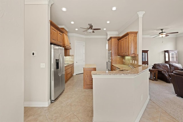 kitchen featuring light tile patterned floors, stainless steel appliances, open floor plan, and a ceiling fan