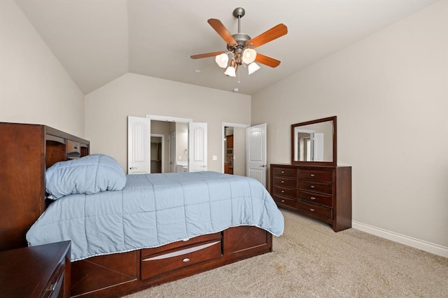 bedroom with ensuite bathroom, carpet flooring, baseboards, ceiling fan, and vaulted ceiling