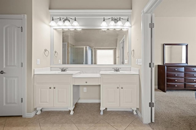 full bathroom featuring double vanity, tile patterned flooring, a shower stall, and a sink