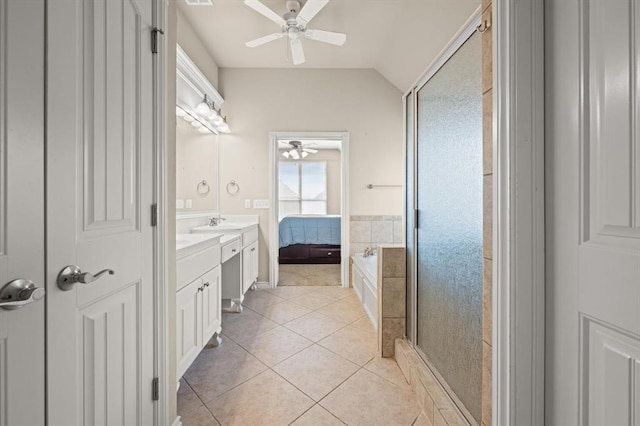 full bath with a ceiling fan, double vanity, lofted ceiling, a stall shower, and tile patterned floors