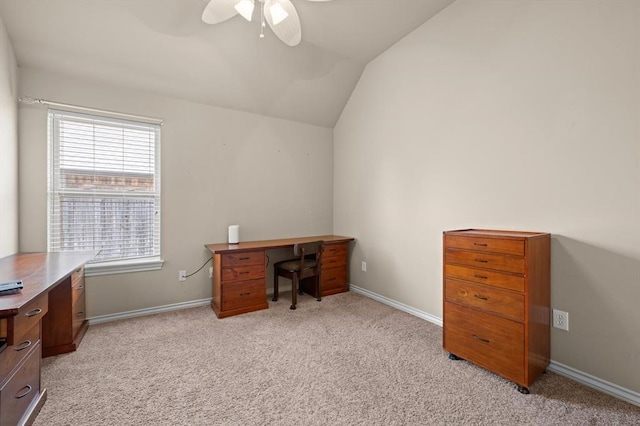 office area with baseboards, light carpet, ceiling fan, and vaulted ceiling