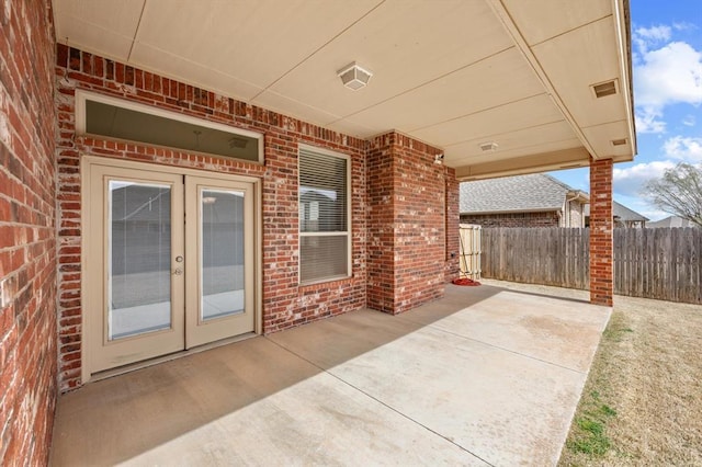 view of patio / terrace featuring french doors and fence