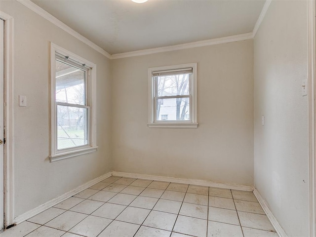 empty room featuring light tile patterned floors, crown molding, and baseboards