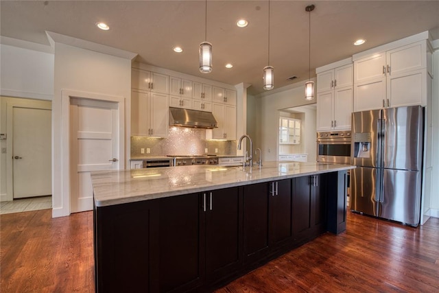 kitchen featuring under cabinet range hood, appliances with stainless steel finishes, dark wood-style floors, and white cabinetry