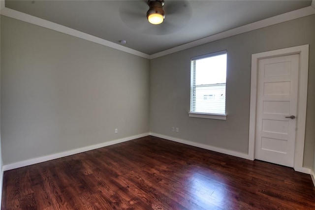 spare room featuring baseboards, dark wood finished floors, a ceiling fan, and ornamental molding