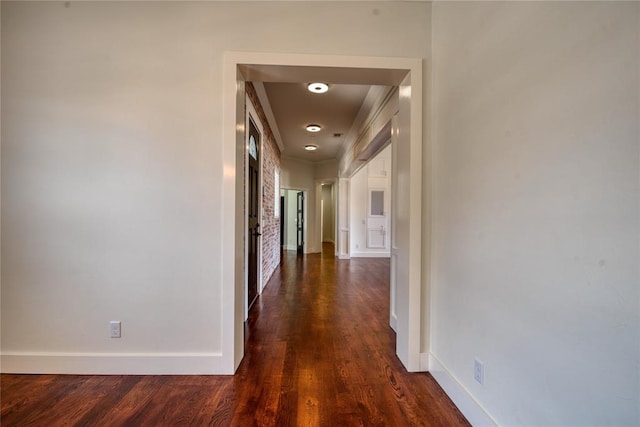 hall with dark wood finished floors and baseboards