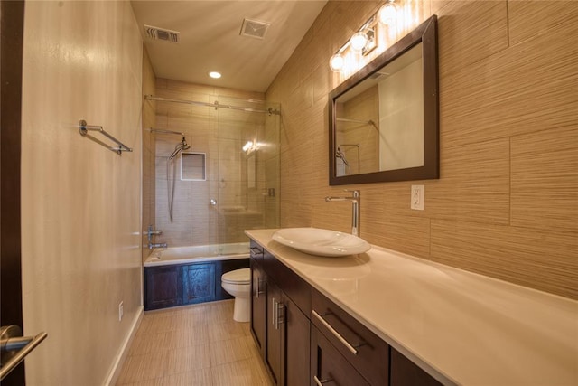 full bathroom with vanity, shower / bathing tub combination, toilet, and visible vents