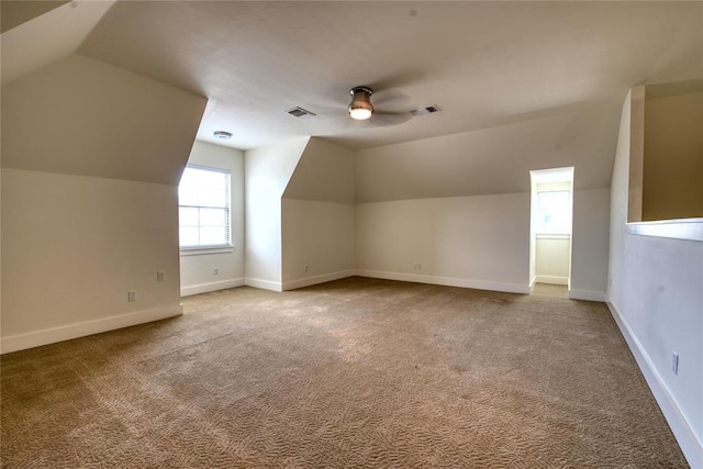 bonus room with visible vents, carpet flooring, baseboards, and a ceiling fan