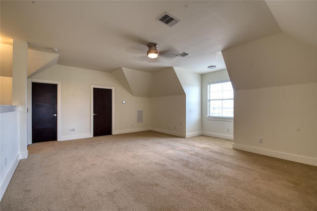 bonus room with visible vents, light carpet, ceiling fan, and vaulted ceiling