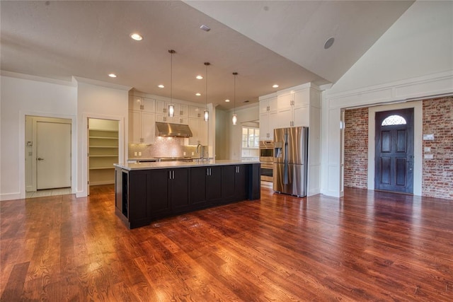 kitchen with under cabinet range hood, dark wood finished floors, stainless steel appliances, white cabinets, and light countertops