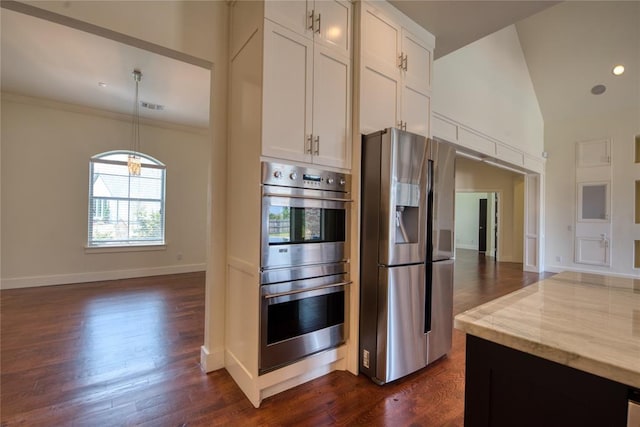 kitchen with vaulted ceiling, appliances with stainless steel finishes, baseboards, and dark wood-style flooring