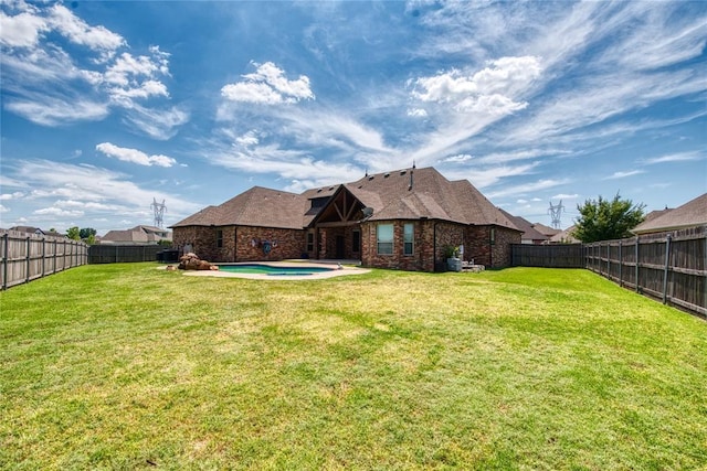 view of yard featuring a jacuzzi and a fenced backyard