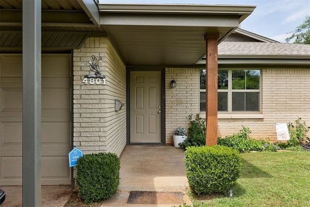 4801 Del Crest Dr, Del City, OK 73115 - property entrance with brick siding, a porch, and roof with shingles