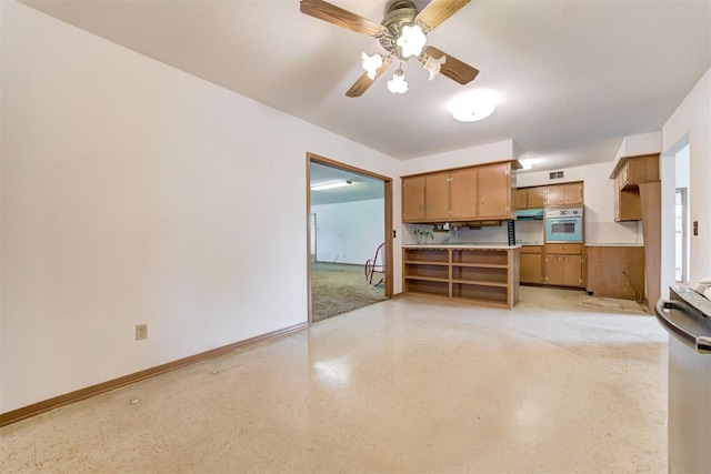 4801 Del Crest Dr, Del City, OK 73115 - kitchen with brown cabinets, ceiling fan, oven, and light countertops
